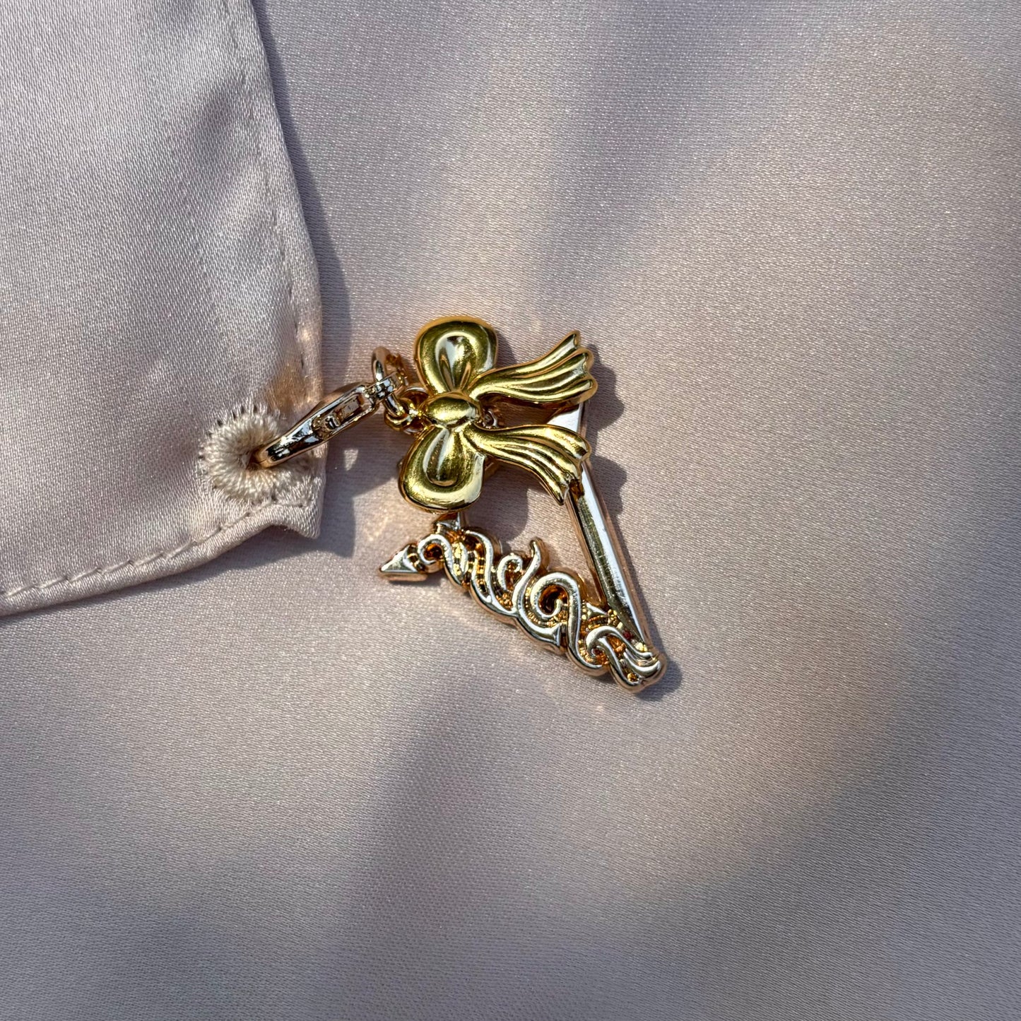 Demure bow charm